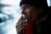 Doug Harding smokes a cigarette in downtown Ogden as he waits to hear about a possible apartment that he could move into on Friday, Jan. 15, 2016. Harding says he enjoyed the hobo life for decades, but began thinking of settling down when a fellow train rider asked him if he was still going to be riding the rails at 75.