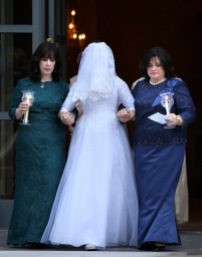 Sharonne Zippel, left, and Rosa Cohen, right, escort Chaya Zippel, the bride, during her wedding at the Grand America Hotel in Salt Lake City on Monday, Sept. 12, 2016. The bride wears an opaque veil in traditional hasidic weddings to emphasize marrying for inner beauty. It is the first traditional Hasidic Jewish wedding in the state of Utah.